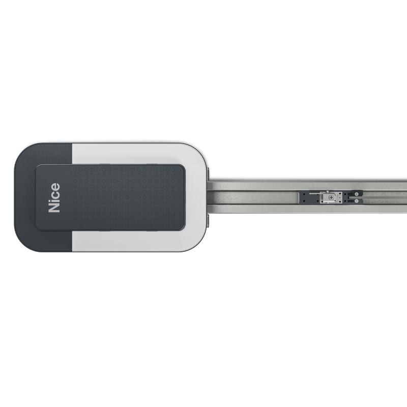 Na drugim zdjęciu widok z góry przedstawia obudowę silnika urządzenia do otwierania garażowych drzwi rolowanych, w kolorach czarnym i białym z napisem Nice, a po prawej stronie metalowa szyna z mechanizmem przesuwu.